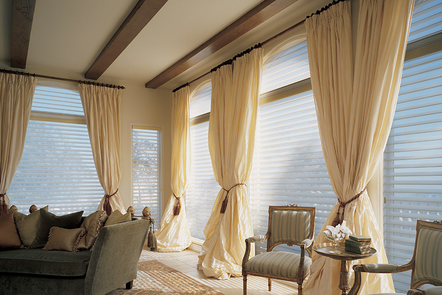 Coordinated window treatments in a comfortable, naturally lit home interior